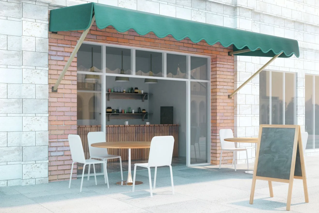 Cafe with a green awning and outdoor seating